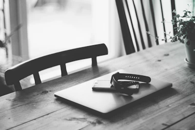 A minimalist workspace with fitness products arranged neatly on a wooden table.