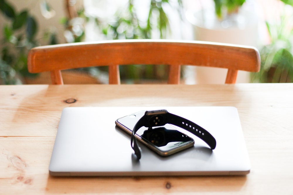 silver MacBook Pro on brown wooden table