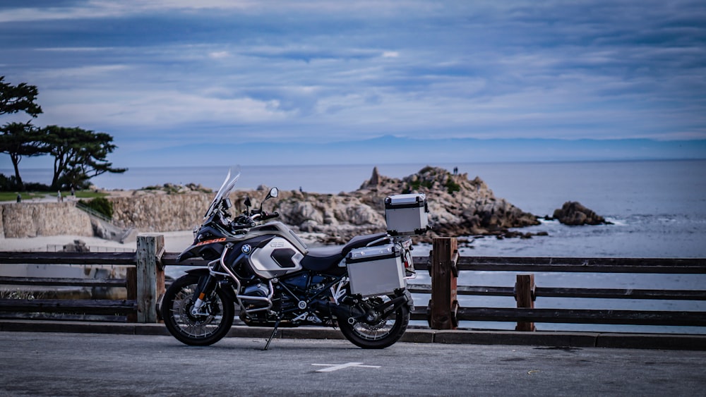 a motorcycle parked next to a wooden fence