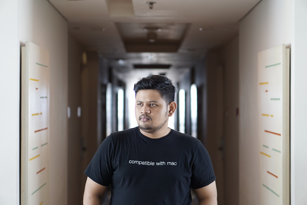 man standing in the middle of hallway