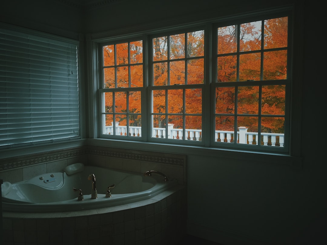 white bath tub near window