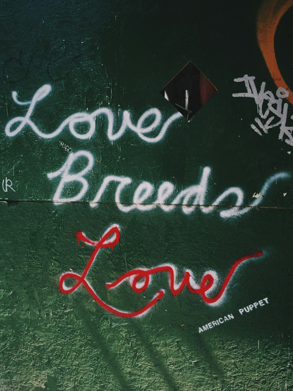 graffiti on a wall that says, love, bread, love