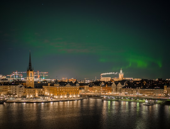 aurora sky phenomenon in cityscale near ocean in Mariaberget Sweden