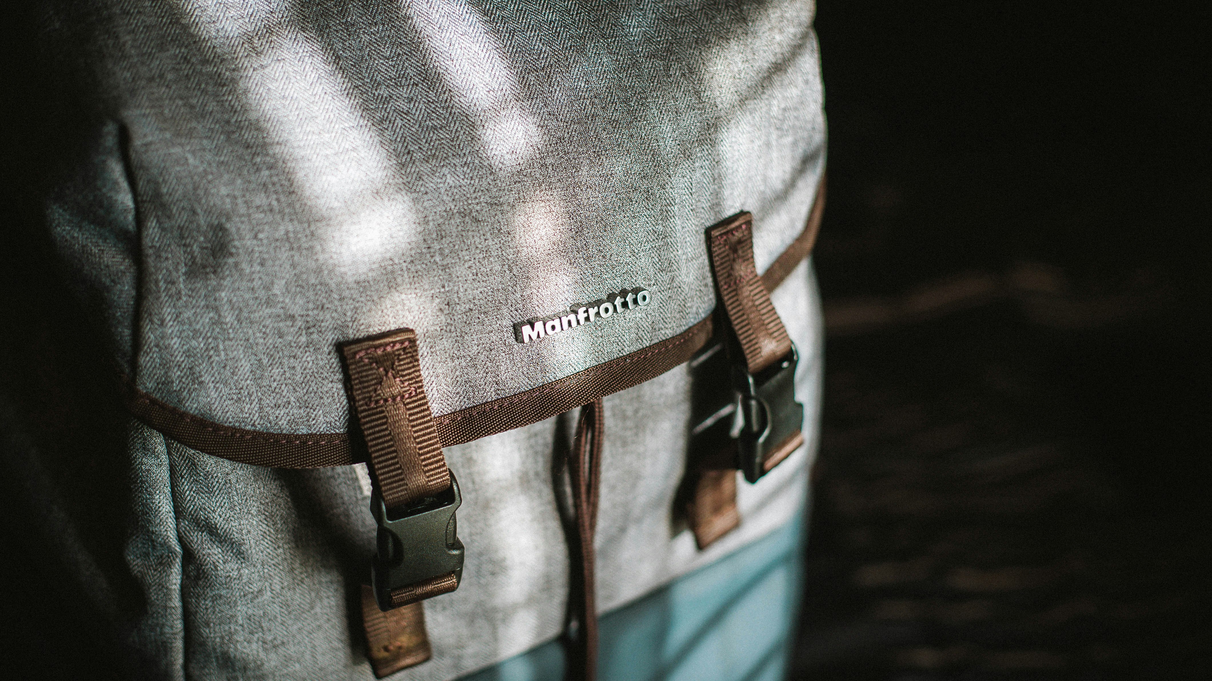 close-up photograph of gray and brown snap backpack