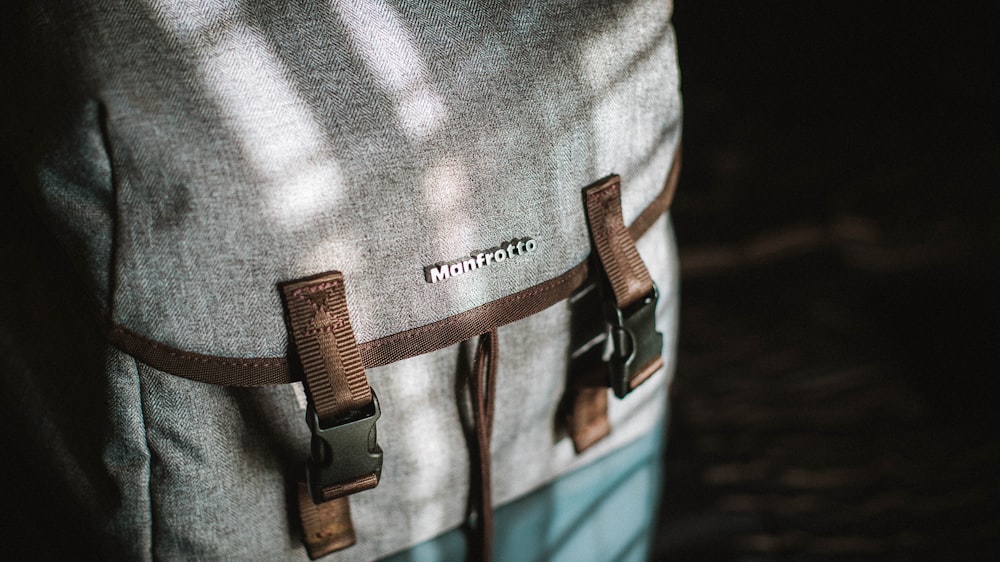 close-up photograph of gray and brown snap backpack