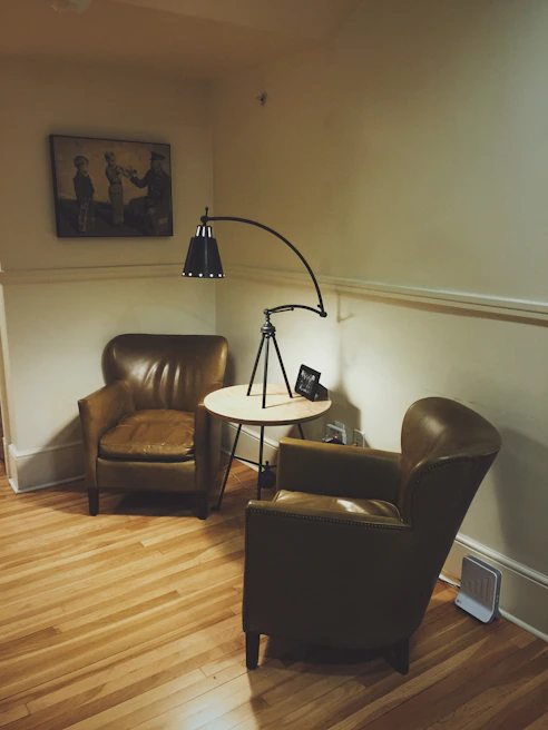 Cozy living room corner featuring a distressed leather armchair and a reclaimed wood coffee table
