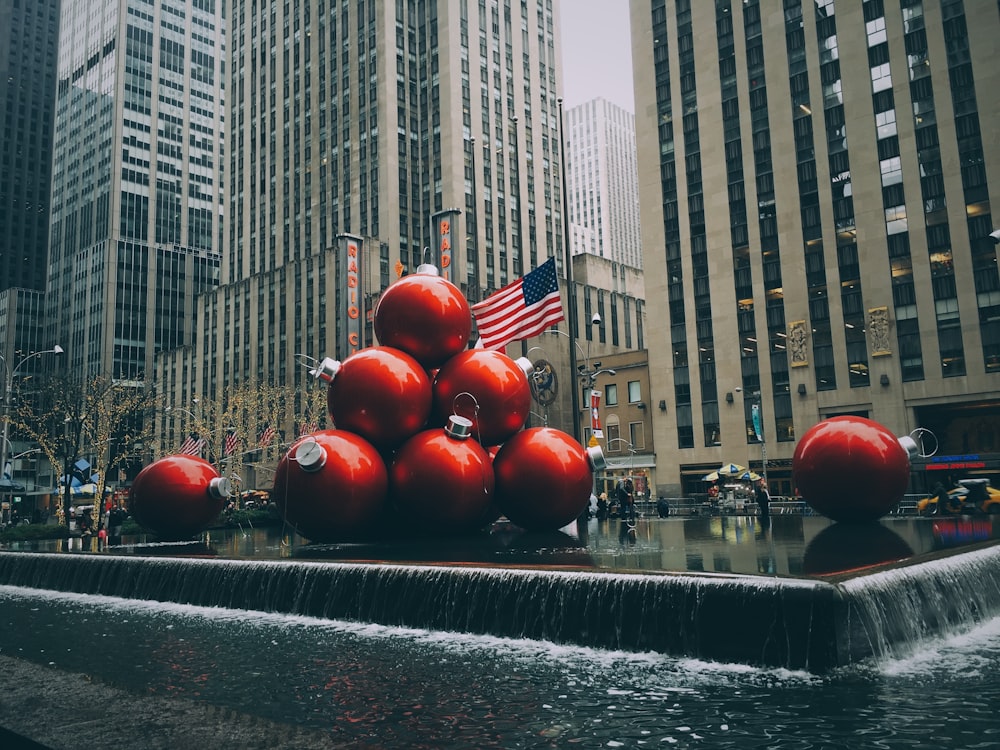 red bauble fountain near buildings