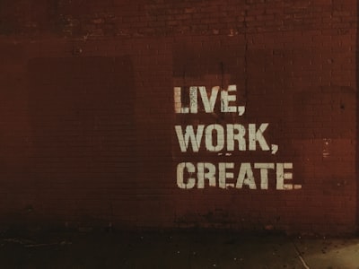 red brick wall with live, work, create. quote text teams background