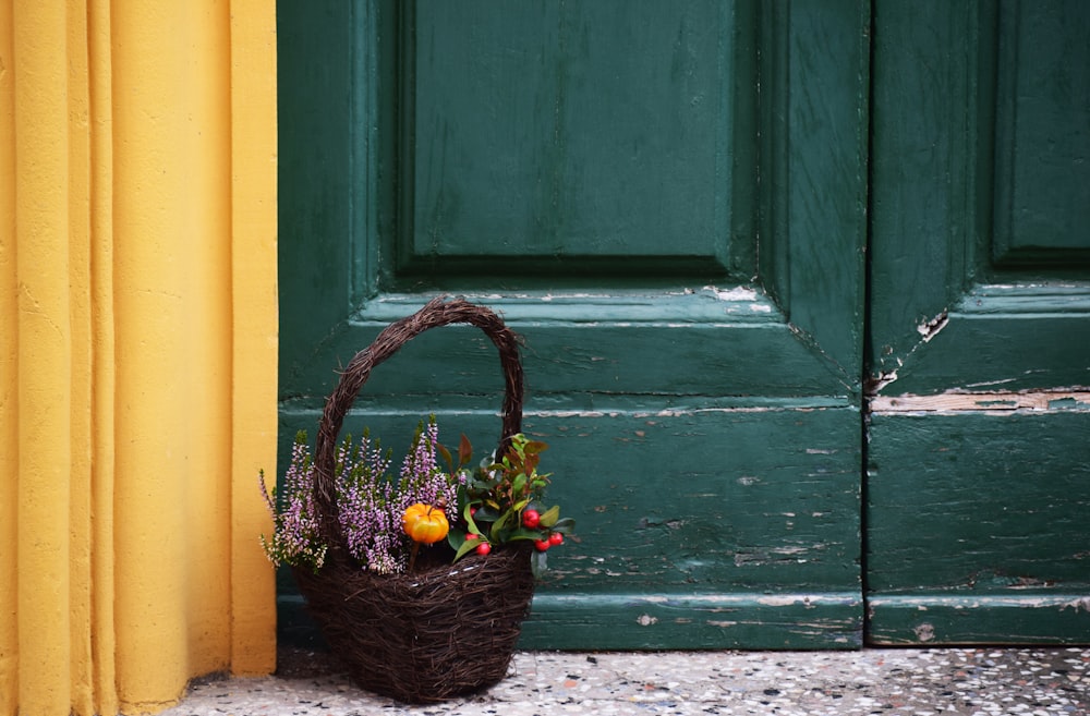 brown basket filled with flower near door