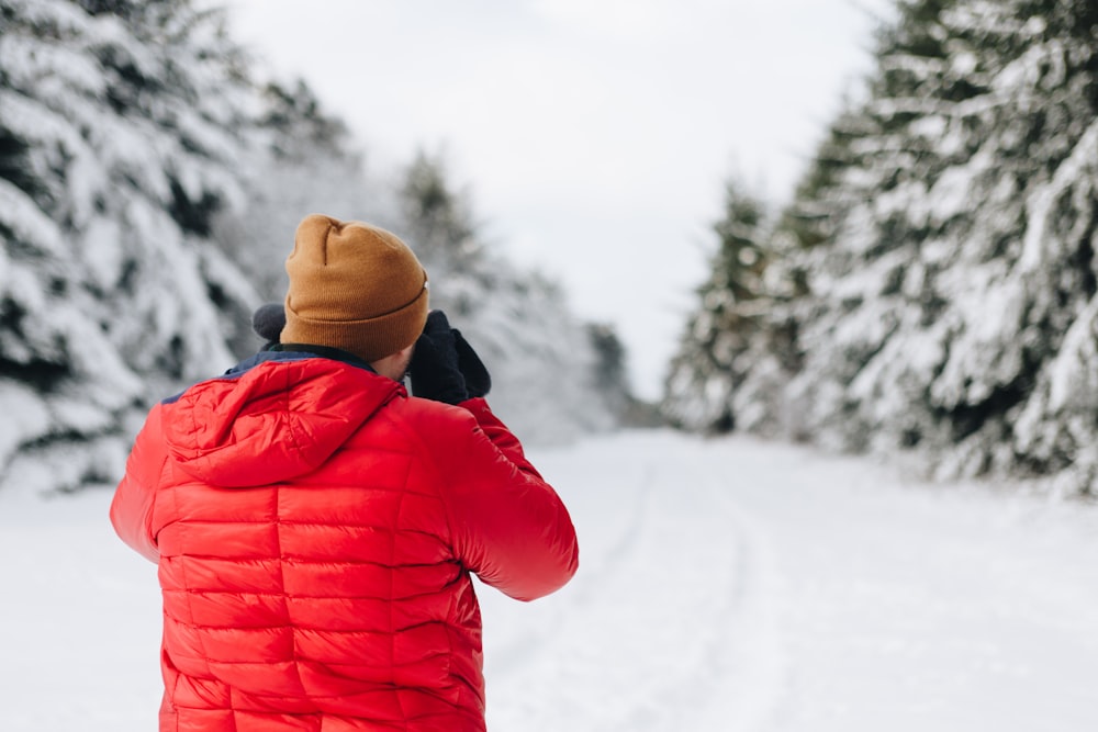 man wearing bubble jacket in snow