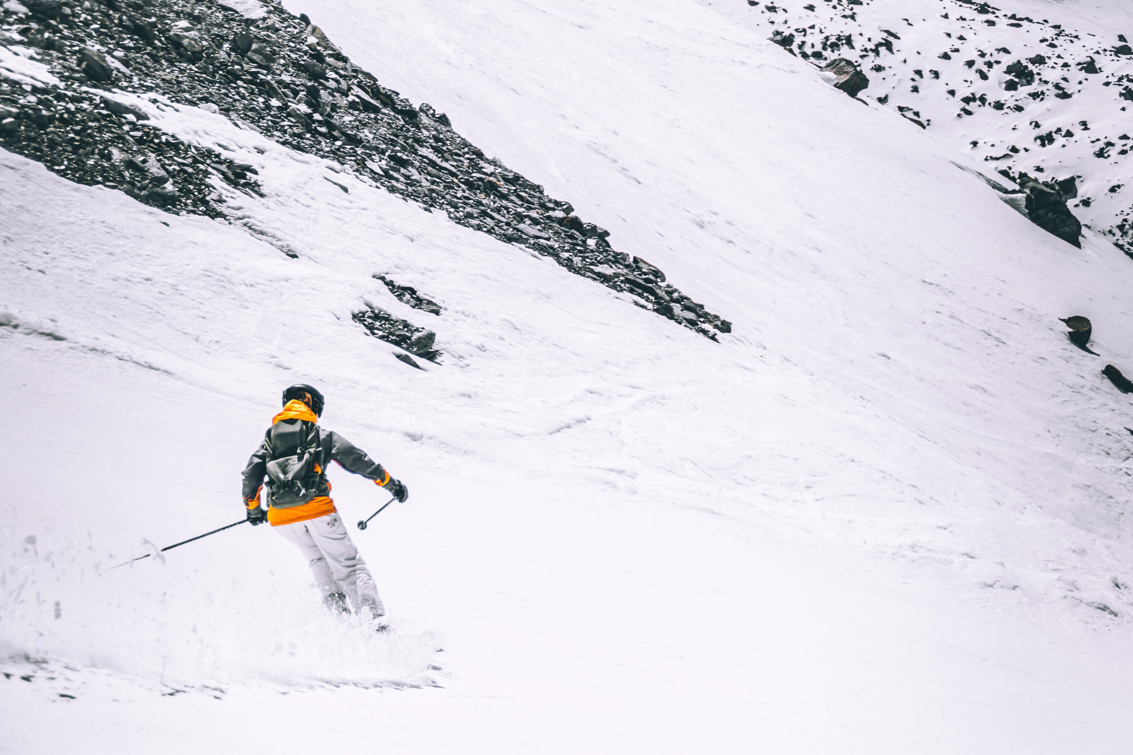 A skier carving down a groomed piste in Val Thorens