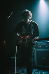band guitarist under spot light