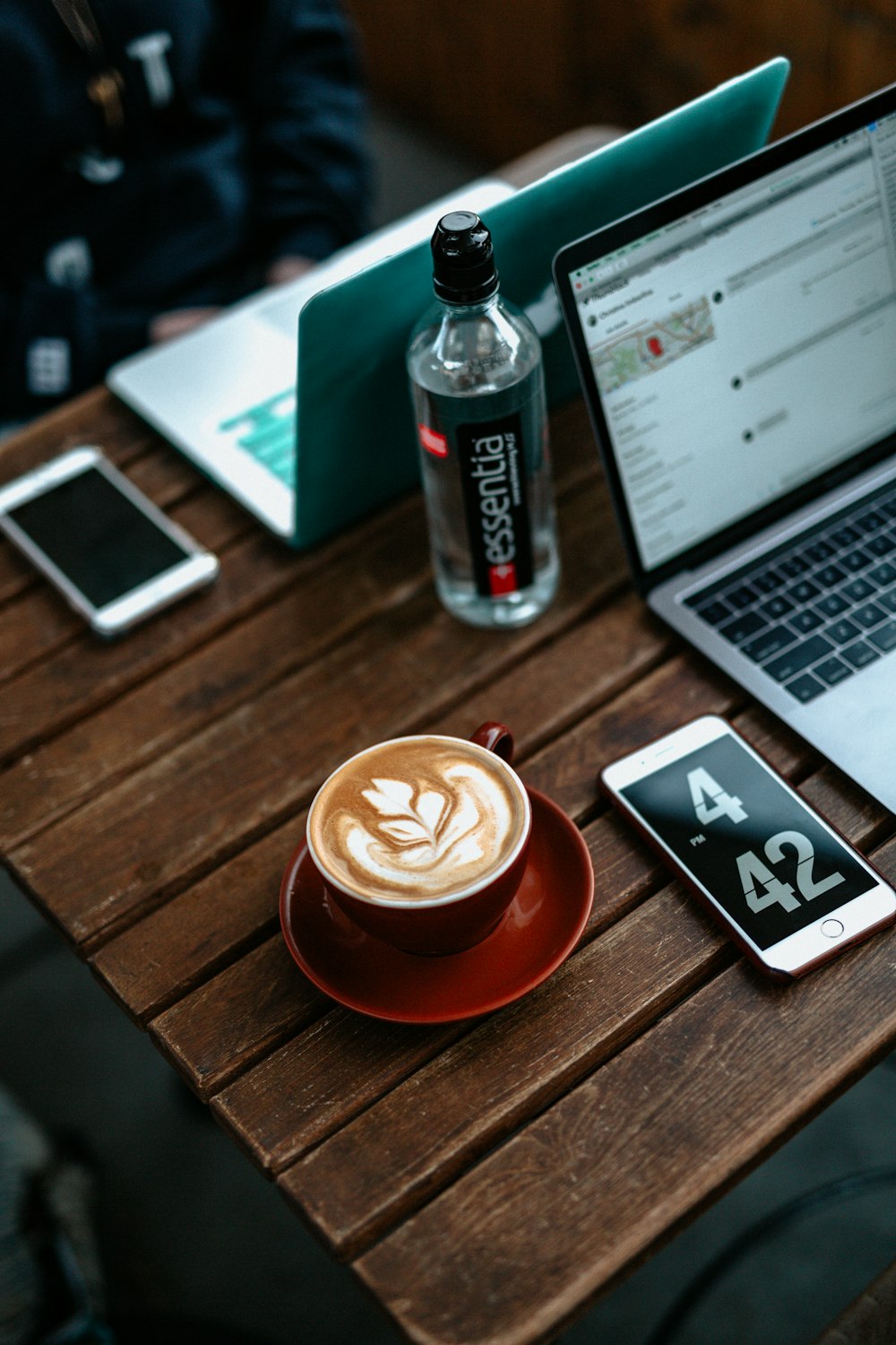 cappuccino on table beside iPhone