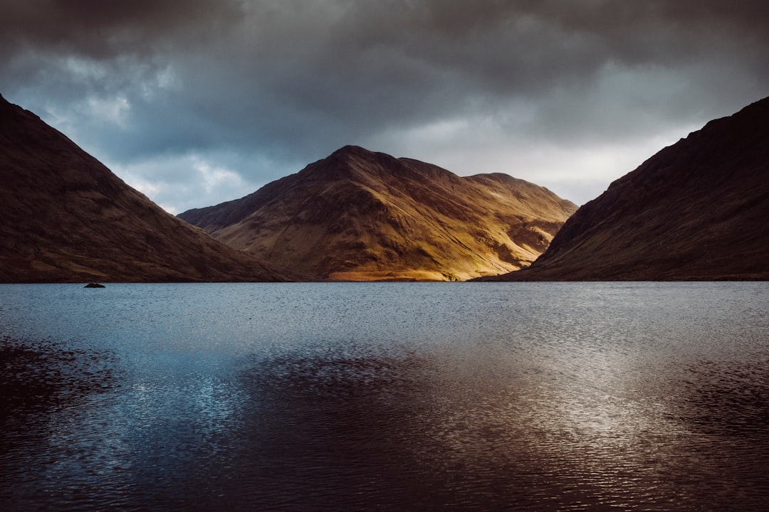 body of water near mountains