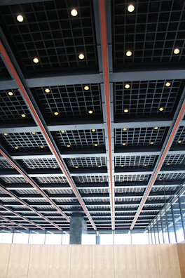 A spacious commercial area showcasing a grid ceiling system with recessed fixtures.