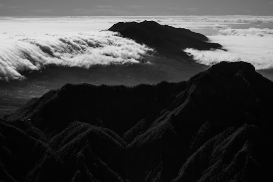 grayscale photography of mountain covered by clouds in Roque de los Muchachos Spain