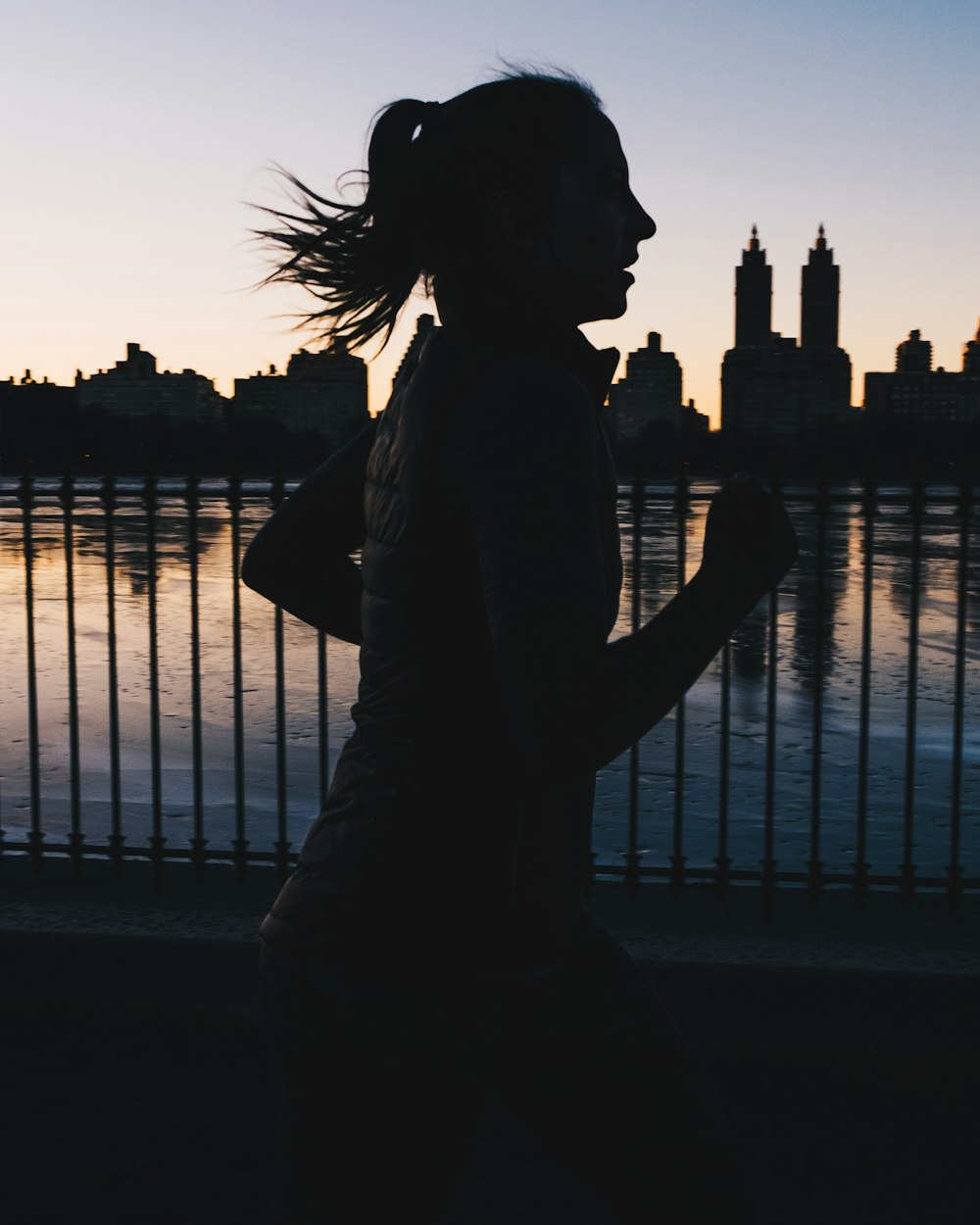 silhouette photo of woman running