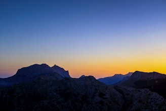 A picturesque view of a mountain landscape at sunset.