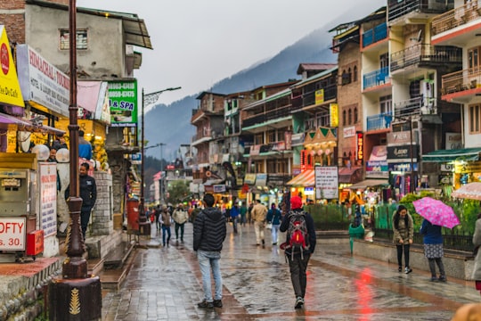 several people waling in street in Manali India