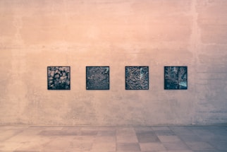 four black wall arts on brown wall