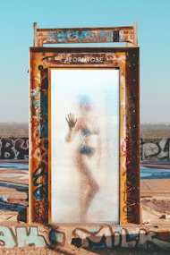 person inside the brown steel frame