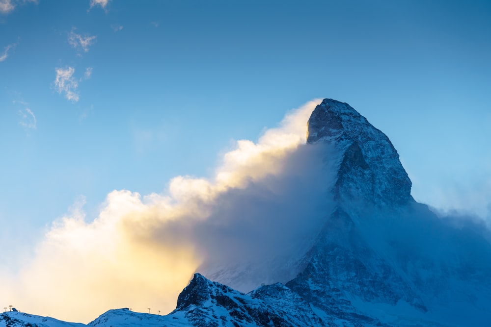 snow covered mountain under blue sky