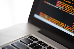 silver laptop computer on white surface