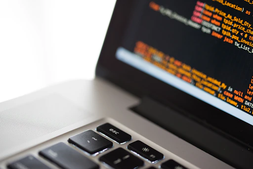 silver laptop computer on white surface