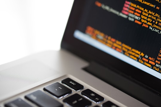 silver laptop computer on white surface