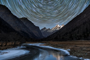 astrophotography,how to photograph back to 4 sisters mountain area in sichuan china, i was there climbing mountain last year. this was a 14km trek into changping valley and we camped in muluozi area, a flat grass grand. in december, it was very cold and windy about -10c. the mountain at back is a technical 5000+ mountain called camel peak.; landscape photography of black mountains