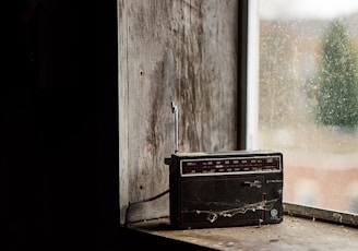 black boombox radio on top window