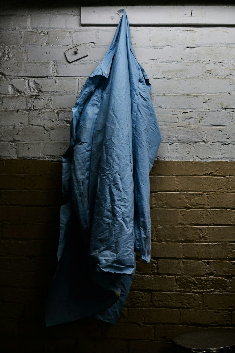 blue windbreaker hanging on hook