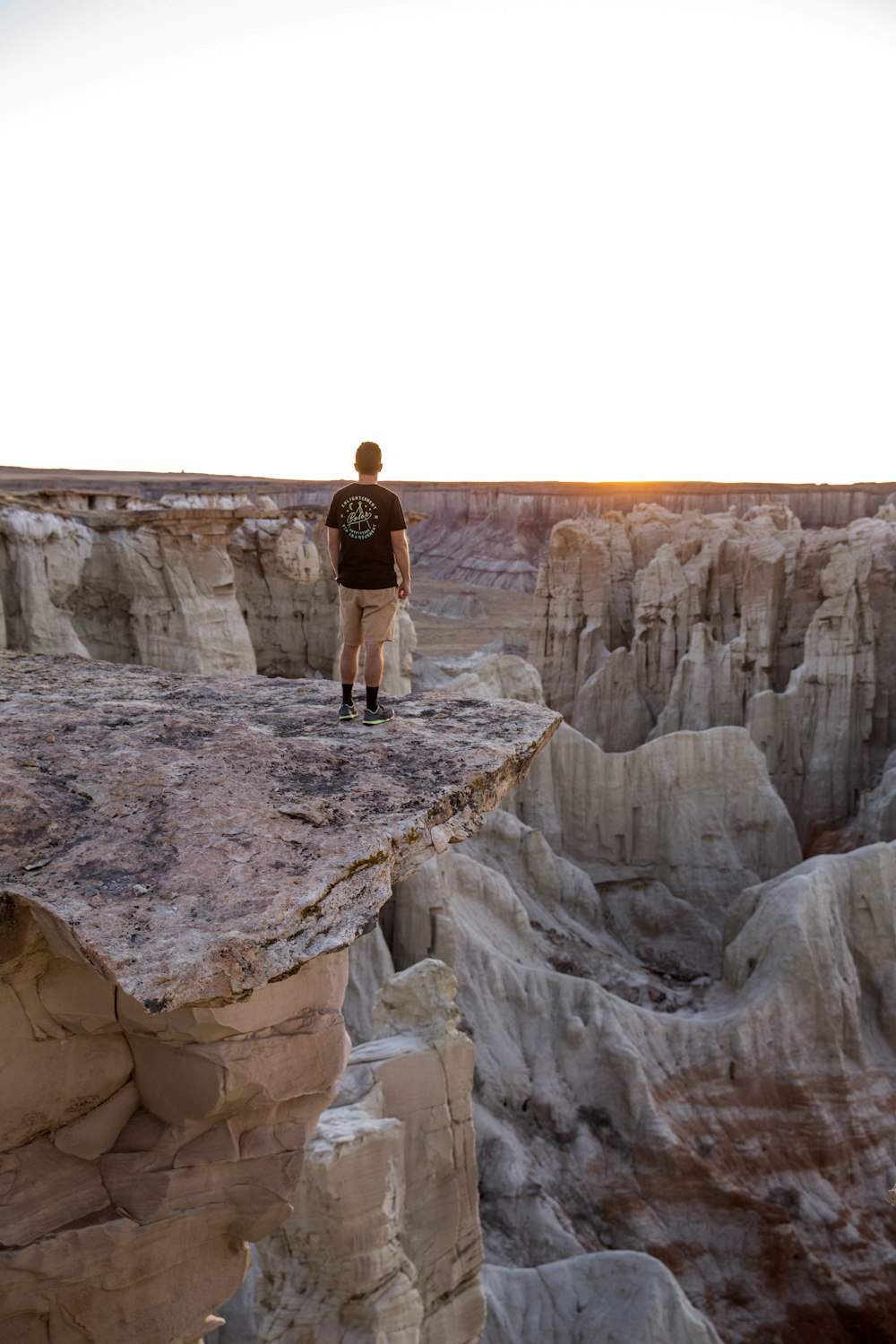 man standing on mountain's edge