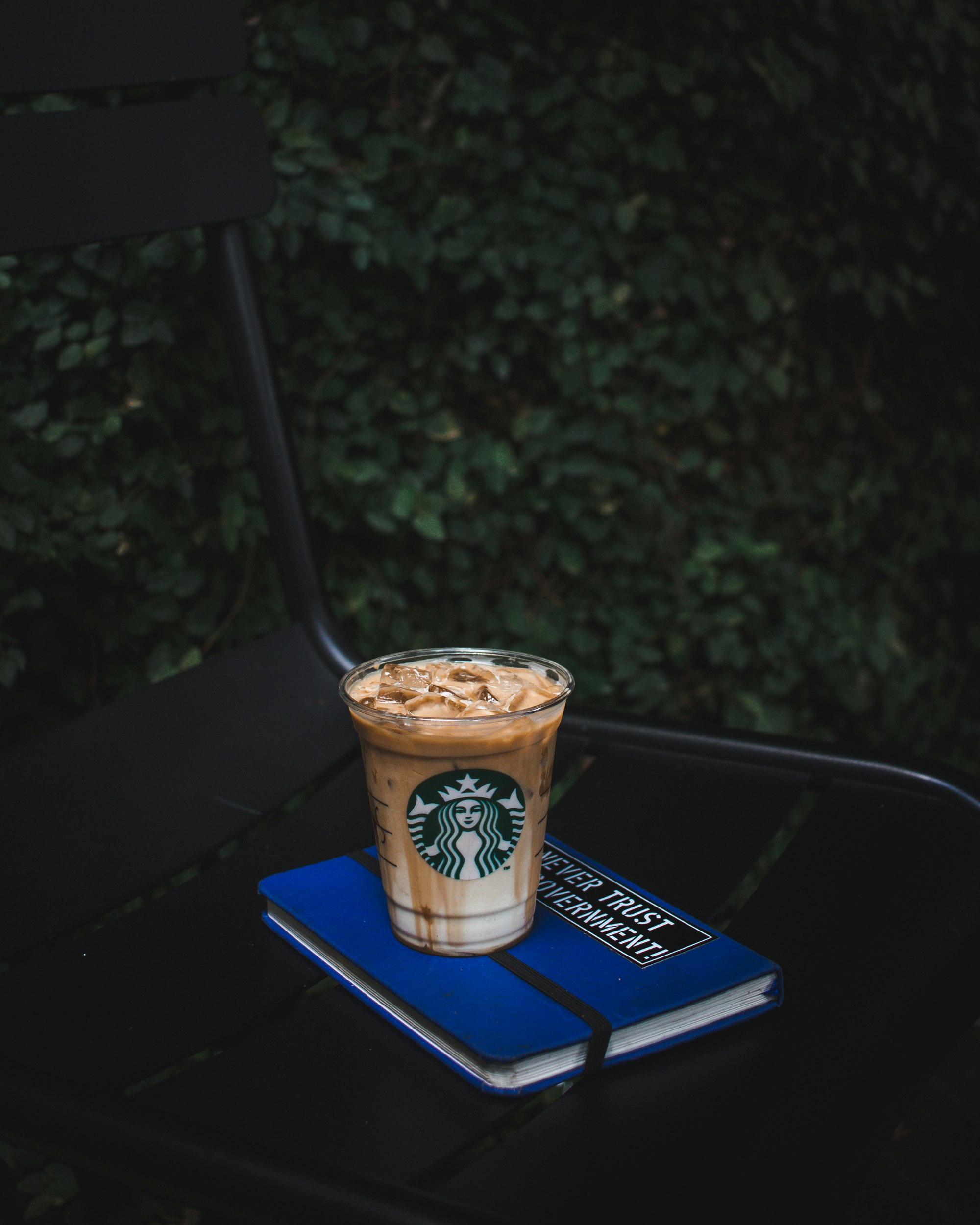 Starbucks plastic cup on blue book