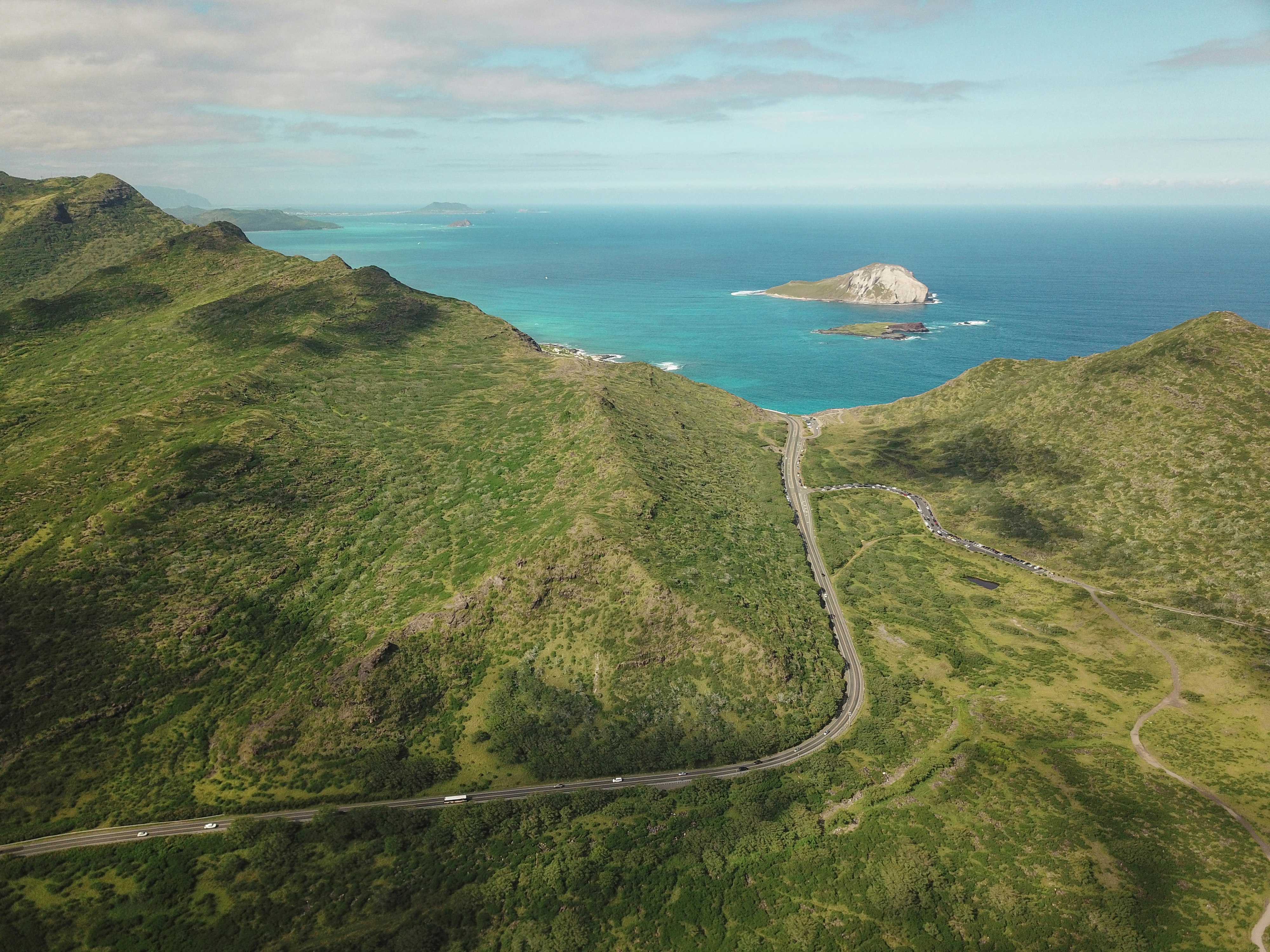 aerial photograph of mountain besides body of water