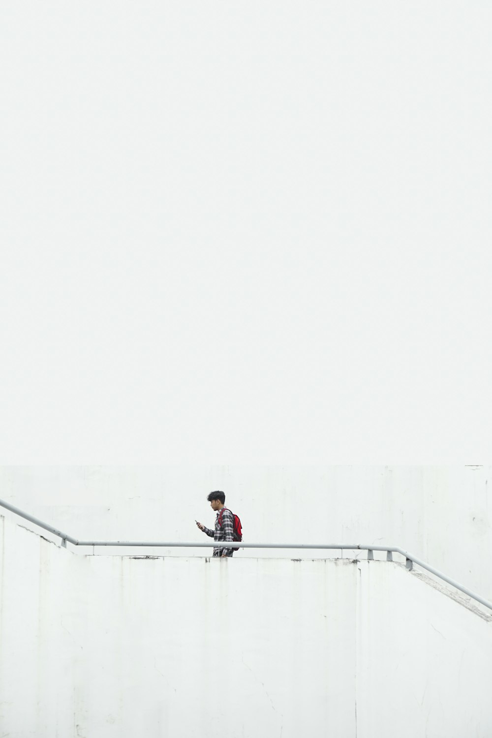 man on stair wearing red backpack