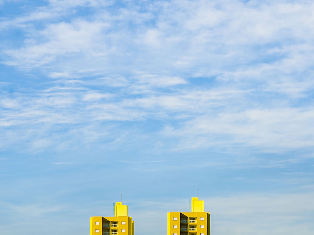 close up photography of two yellow buildings