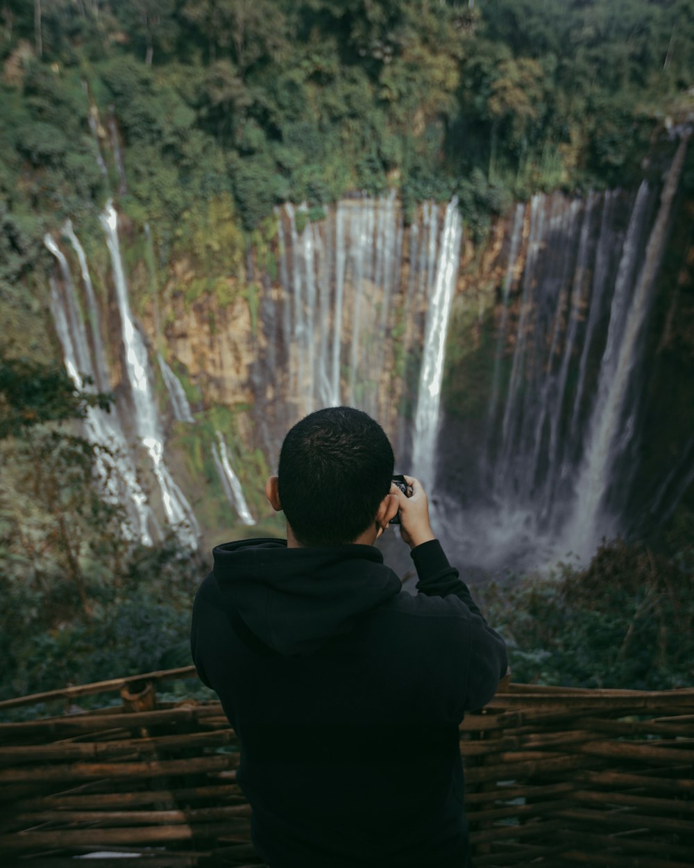 an holding camera capturing falls