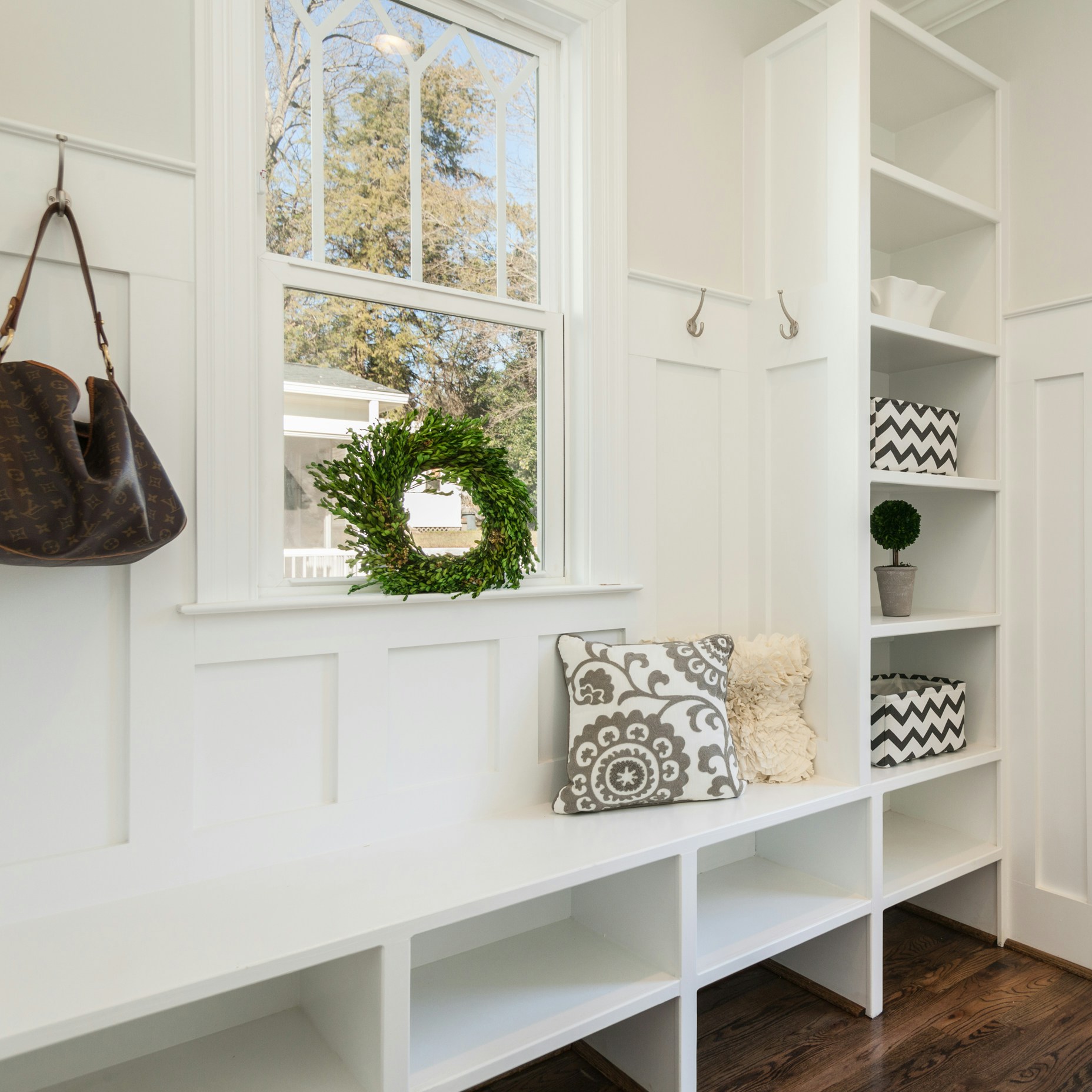 gray and white floral throw pillow beside rack inside room