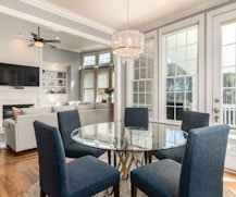 round clear glass-top table and five gray chairs dining se