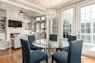 round clear glass-top table and five gray chairs dining se