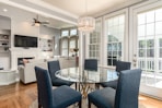 round clear glass-top table and five gray chairs dining se