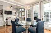 round clear glass-top table and five gray chairs dining se