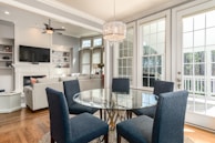 round clear glass-top table and five gray chairs dining se