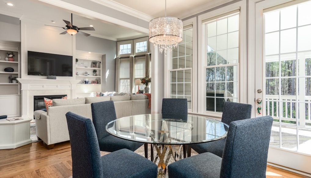 round clear glass-top table and five gray chairs dining se