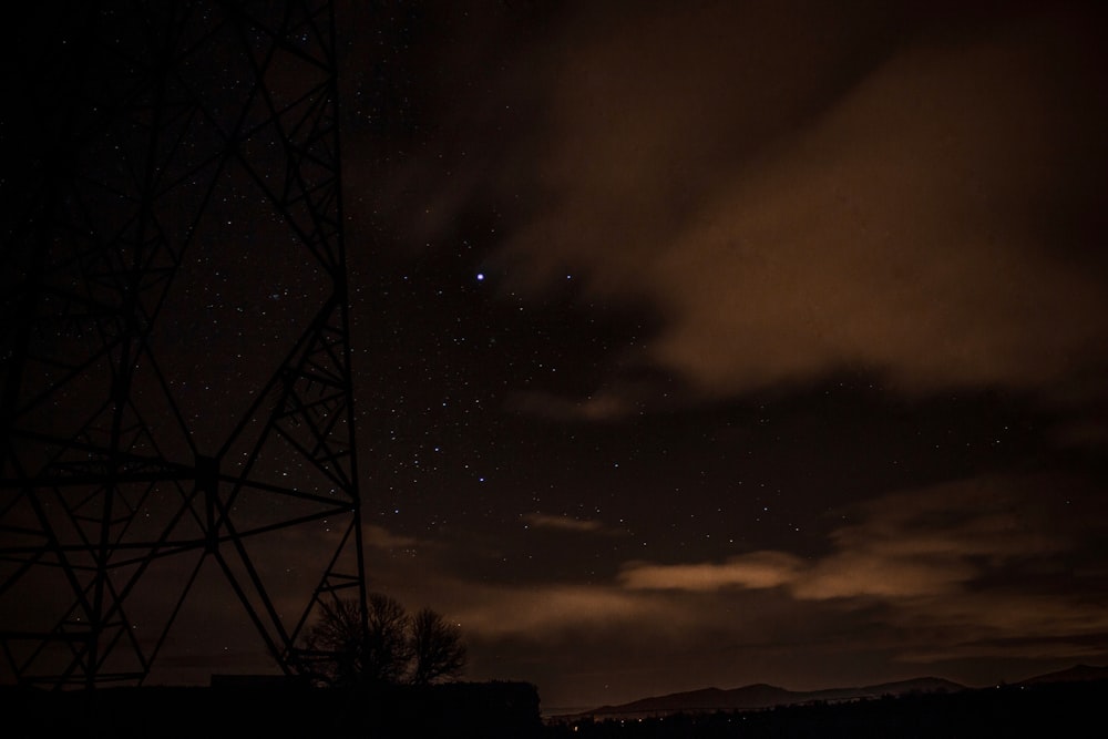 gray metal tower under night sky