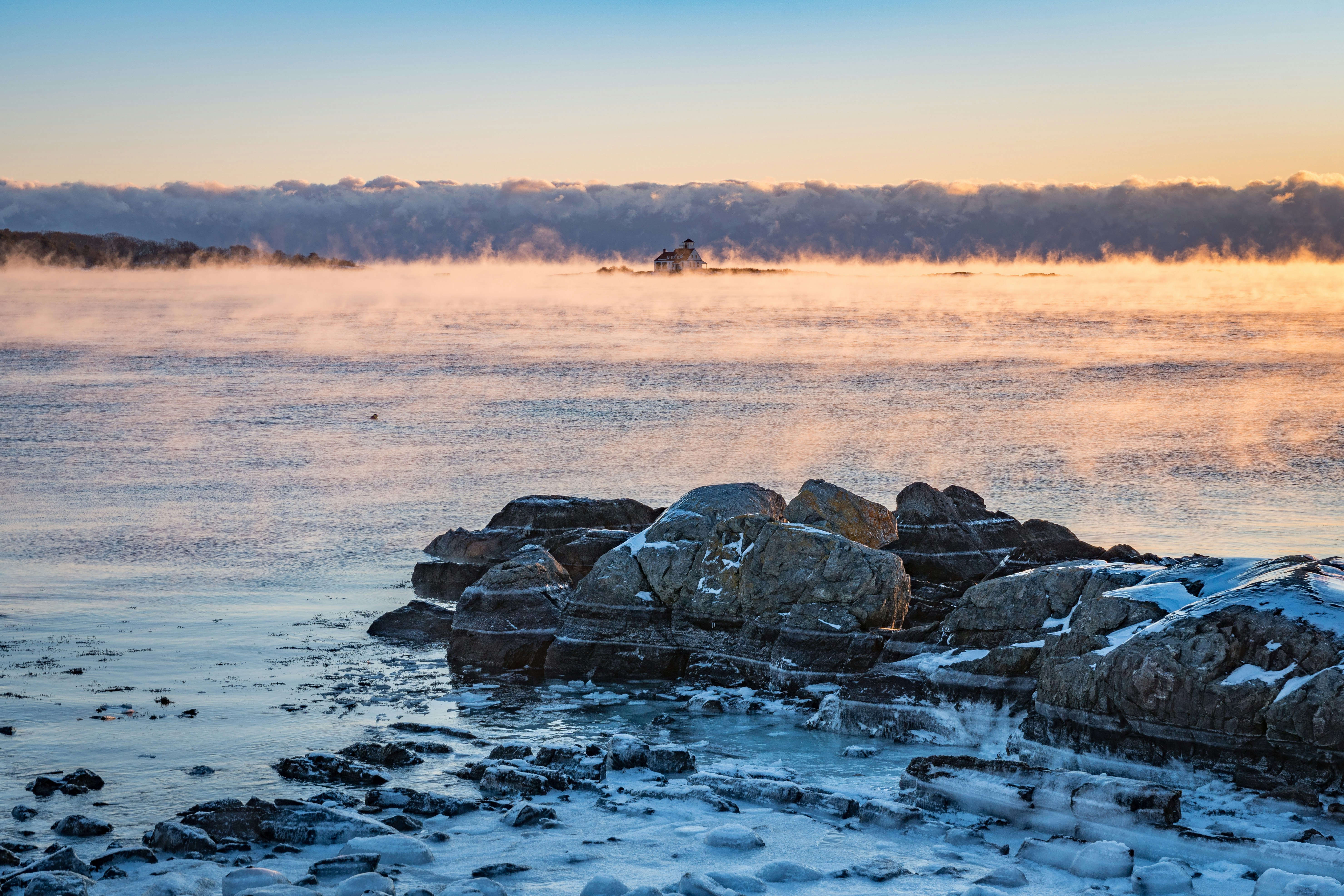 I woke up before dawn on the first day of the New Year (2018) and drove the hour or so to the coast. The temperature was below zero, so I knew I would see some sea smoke. It was -2 F when I arrived, with a breeze making it feel even colder. There were a few other hardy souls taken photos as well, but none of as stayed very long. The recently renovated Wood Island Life Saving station is at the center of the photo.