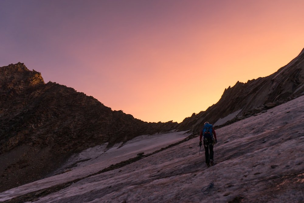 person walking uphill during golden hour