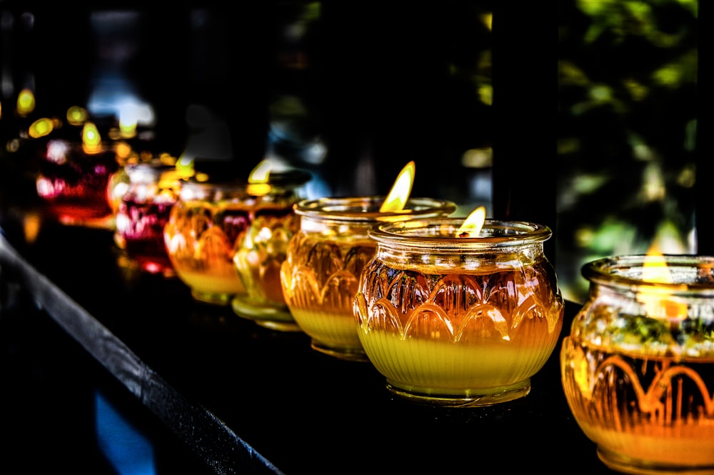 orange glass candle holders with lighted candles
