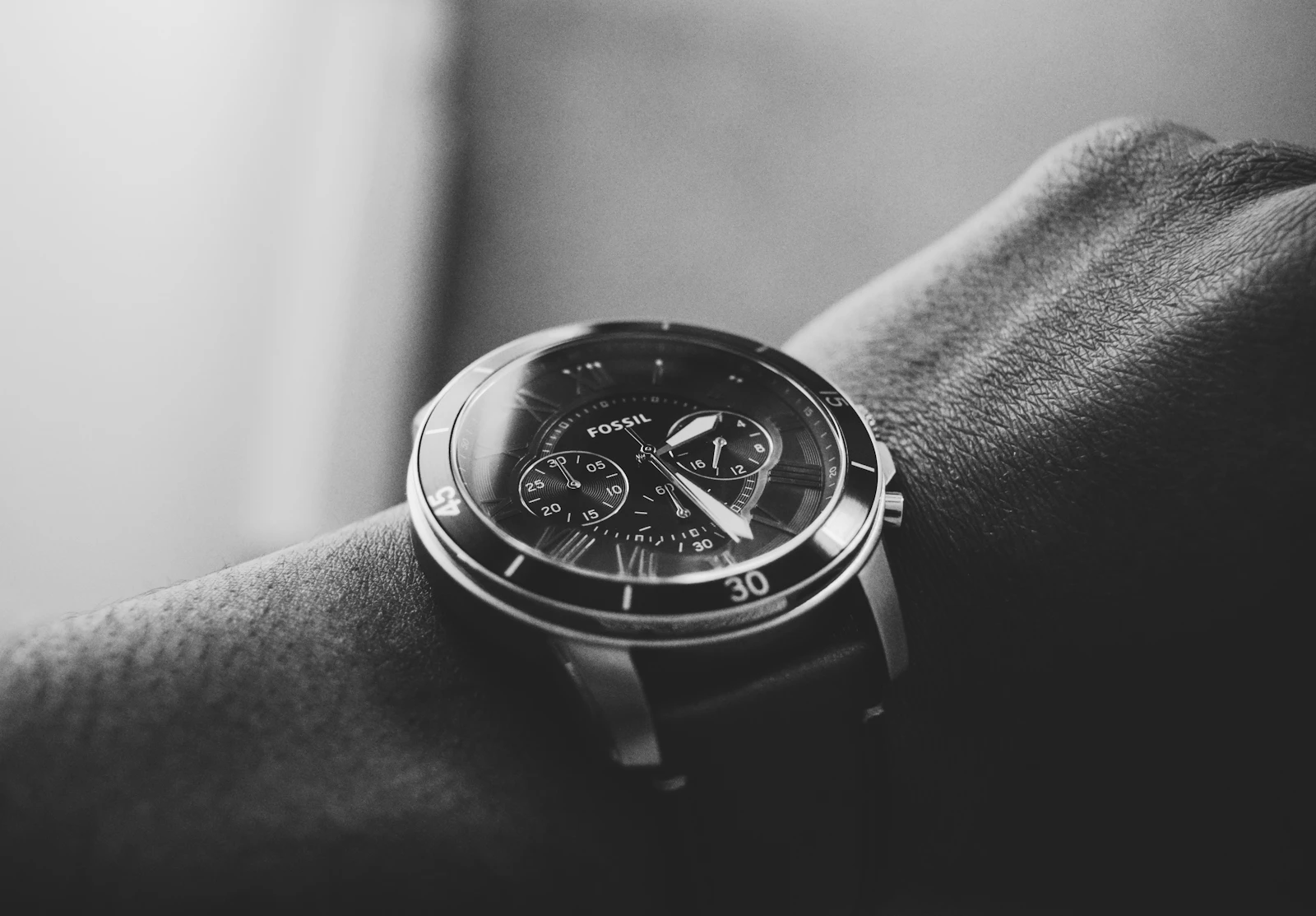Black and white close view of a chronograph watch on a man's wrist
